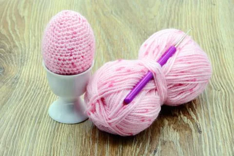 Pink easter eggs crochet of wool in egg cup. wooden background Stock Photos