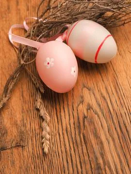 Pink Easter eggs with decoration on a rustic wooden table background 写真素材