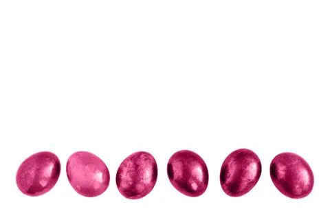 Pink Easter eggs in a row on isolated white background. Stock Photos