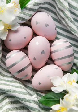 Pink easter eggs with silver patterns and spring flowers 写真素材