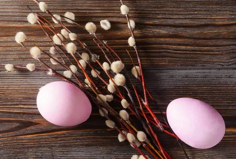 Pink easter eggs, willow branches on a dark wooden background, top view Stock Photos