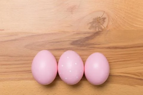 Pink Easter eggs on wooden background Stock Photos