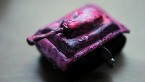 Pink Enameled Tin Toy Wind Up Miniature Tank - 4K  Stock Footage 345267176