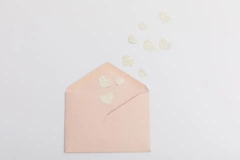 Pink envelope and multiple hearts with text on white background Stock Photos