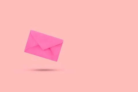 A pink envelope floating on a pink background Foto stock
