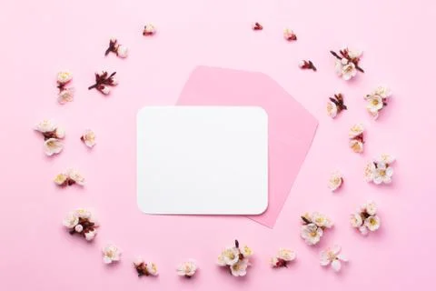 Pink envelope with white sticker inside on a pink paper background decorated Stock Photos