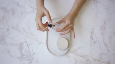 Pink face roller and jade roller laying on white background. Beauty roller tools Stock Footage 142201034