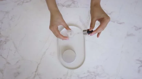 Pink face roller and jade roller laying on white background. Beauty roller tools Stock Footage 142201124