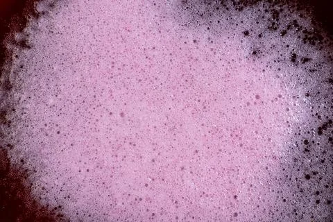 Pink fermentation foam texture with dense bubbles beverage surface macro Stock Photos