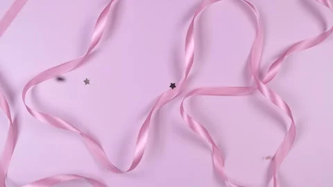 Pink festive delicate pastel background with satin ribbons, the concept of the Stock Footage 246031392