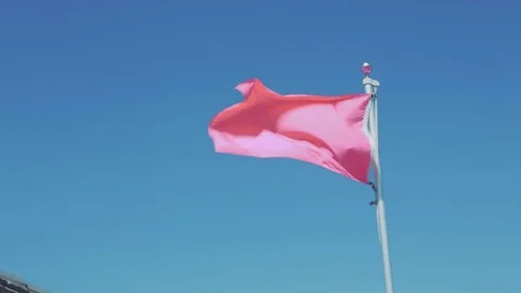 Pink flag blowing in the wind. Stock Footage 77525157