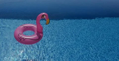 Pink Flamingo Pool Float on Clear Blue Water Stock Photos
