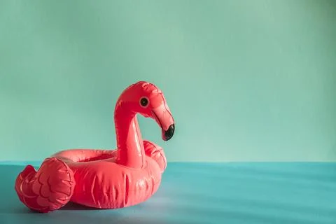 Pink Flamingo Shaped Pool Float on Turquoise Water under Sunlight. Front view Stock Photos