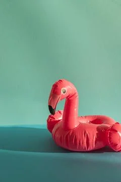 Pink Flamingo Shaped Pool Float on Turquoise Water under Sunlight. Front view Stock Photos