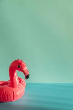 Pink Flamingo Shaped Pool Float on Turquoise Water under Sunlight. Front view Stock Photos
