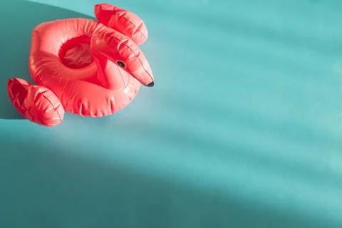 Pink Flamingo Shaped Pool Float on Turquoise Water under Sunlight. Top view Stock Photos