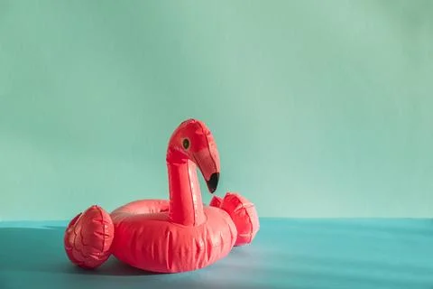 Pink Flamingo Shaped Pool Float on Turquoise Water under Sunlight. Front view Stock Photos