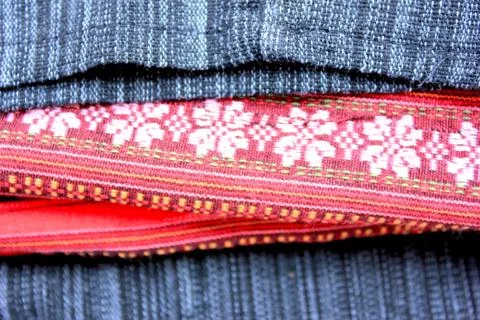 Pink flower in red black pattern in Thai Sarong Stock Photos