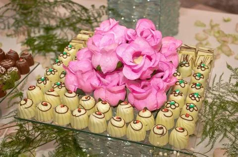 Pink Flowers with Assorted Chocolates Stock Photos