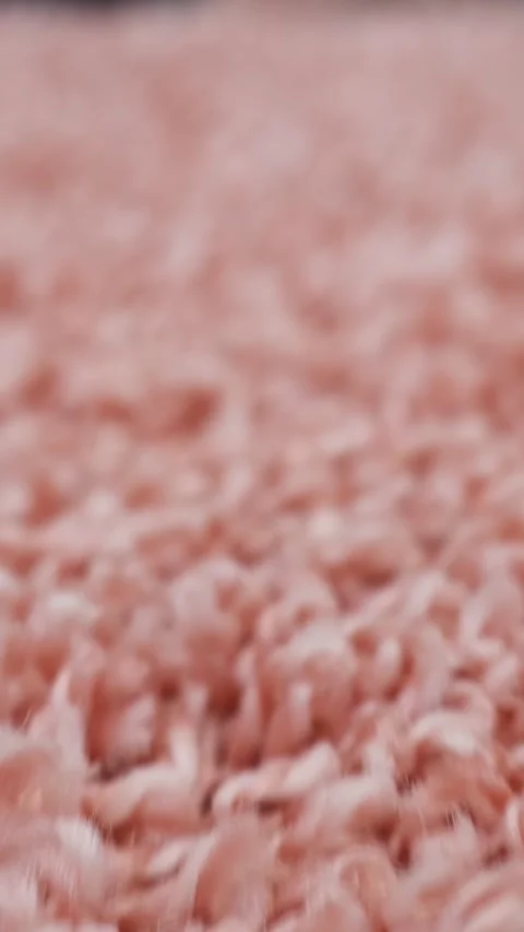 Pink fluffy carpet texture showing a detailed macro view of the soft textile Stock Footage 343907949