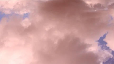 Pink fluffy clouds quickly run across the blue sky. Stock Footage 106353490