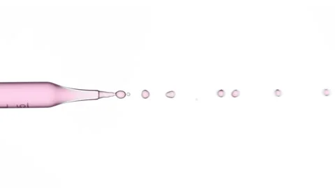 Pink fluid flows from graduated lab dropper Stock Footage 167321934