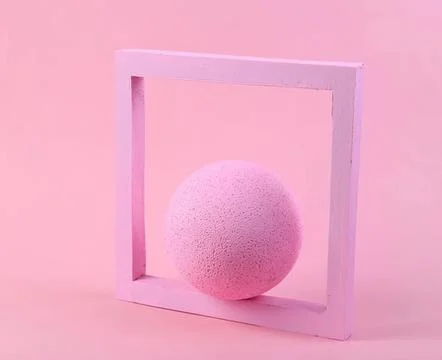Pink foam ball in a square frame on pink background Stock Photos