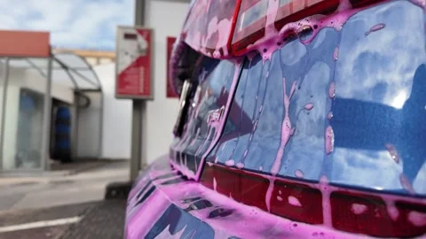Pink Foam on Car Rear Window During Car Wash Close Up Stock Footage 330010132
