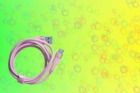 Pink folded usb plug cable for connection on green yelow Stock-Fotos