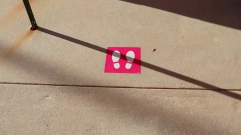 Pink footprints on the ground for social distancing at T-Mobile Stock Footage 143370342