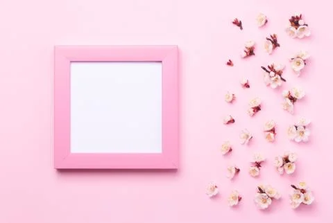 Pink frame with a white sticker inside on a paper pink background. Stock Photos