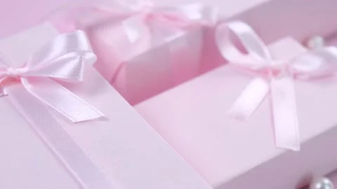 Pink gift boxes with pink bows on a pink background top view, the concept of Stock Footage 217440839