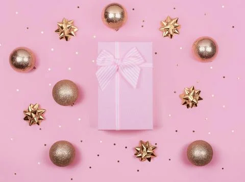 Pink gift or present boxes and gold Christmas decorations on pink background  Stock Photos