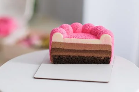 Pink glazed cake with multiple layers of chocolate and mousse. Sweet dessert Stock Photos