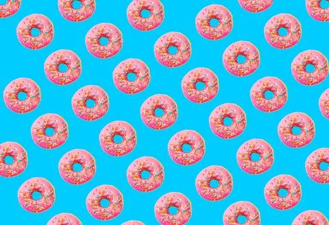 Pink glazed donut pattern on blue pastel background. Creative concept. Stock Photos