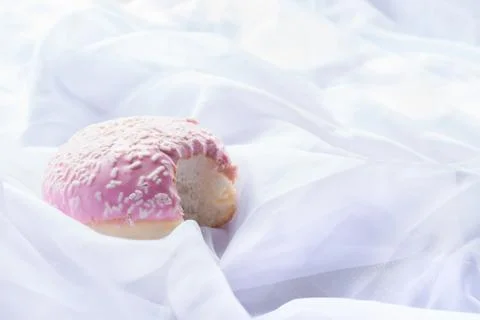 Pink glazed doughnut with a bite missing Stock Photos