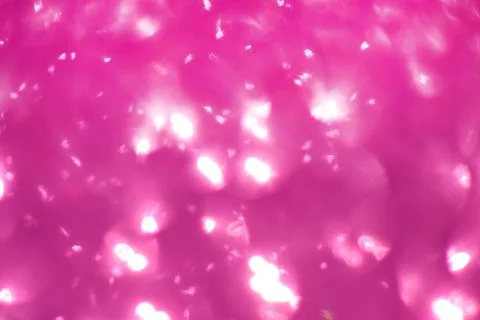 Pink glitter, blurred effect. Glowing holiday light circles are created from Stock Photos