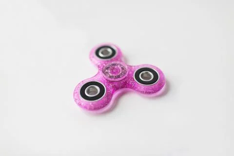 Pink glittered fidget spinner Stock Photos