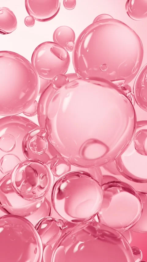 Pink glossy serum bubbles floating and moving slowly in a vibrant abstract .. 스톡 동영상 327342714