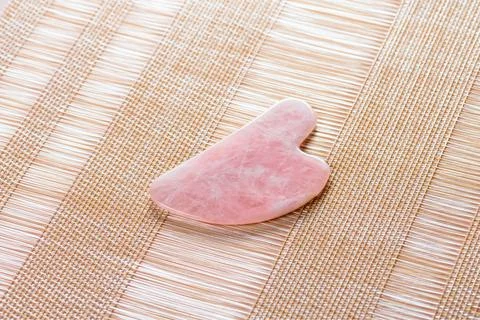 Pink gua sha for the face. Stock Photos