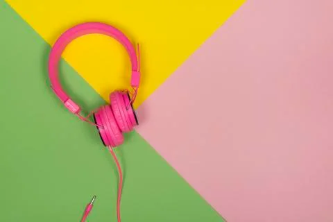 Pink headphone on a multi colored background Stock Photos