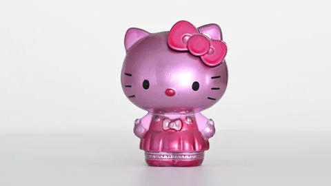 Pink Hello Kitty figurine rotating on white background Stock Footage 333199780