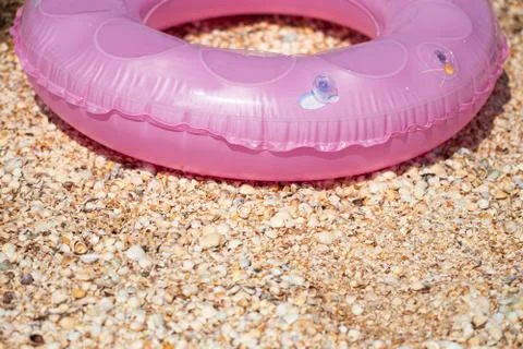 Pink inflatable circle on beach background with copy space Stock Photos