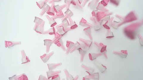Pink insulin pen needles falling in slow motion isolated on a white background Stock Footage 335025813