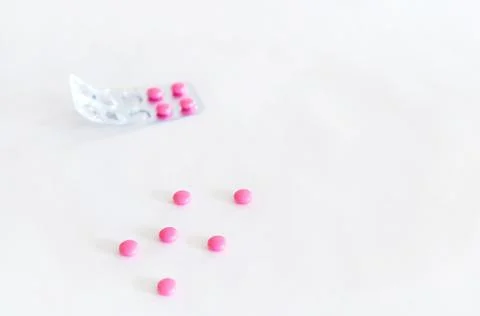Pink isolated tablets on a white background. Stock Photos