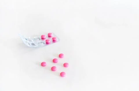 Pink isolated tablets on a white background. Stock Photos
