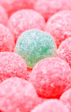 Pink jelly tots with a green jelly tot Stock Photos