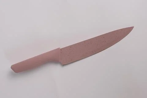 A pink knife on a white background. Stock Photos