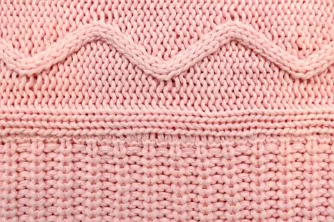 Pink knitted texture with geometric waves. Foto stock