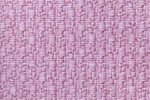 Pink knitted woolen background with a pattern. Texture of textile closeup. Stock Photos